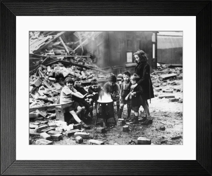 Framed Print : Children in a Manchester suburb warm themselves by a fire outside wrecked houses during Framed Print : Children in a Manchester suburb warm themselves by a fire outside wrecked houses during