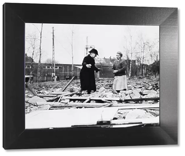 A German civilian views wreckage of her home that was destroyed by a German artillery