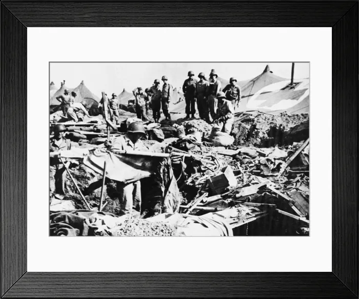 Framed Print : Private Robert Phillips retrieves a cot from a bomb crater after an American hospital Framed Print : Private Robert Phillips retrieves a cot from a bomb crater after an American hospital