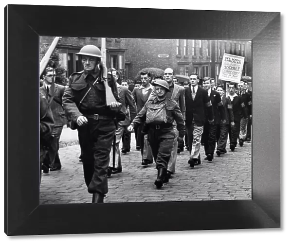 The latest recruits carry a poster in a march of the 77th Lancashire (Bootle