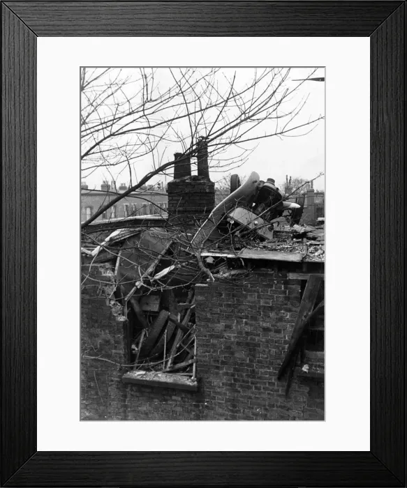 Framed Print : A London Fire Service auxiliary van thrown on to a roof by a falling bomb during