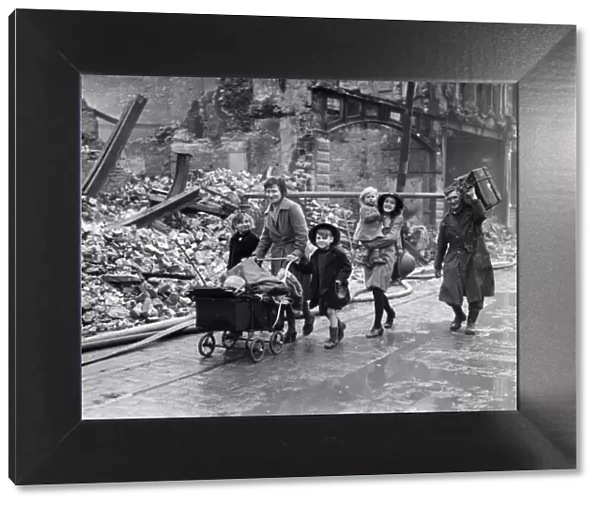 Mr C. E. Mill and family passing through the devastated streets of residential Plymouth