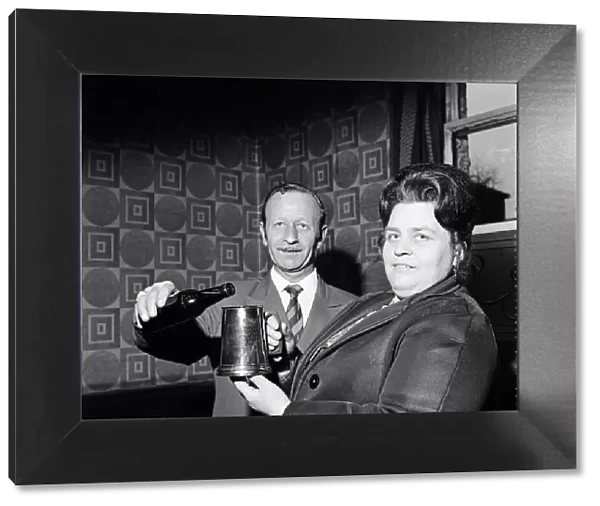Pub landlord presents a tankard to a widow, Teesside. 1974