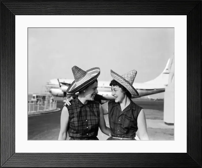 Framed Print : School teacher, 23 year old Phyllis Kaulfman (left), is not short of hats for her flight Framed Print : School teacher, 23 year old Phyllis Kaulfman (left), is not short of hats for her flight