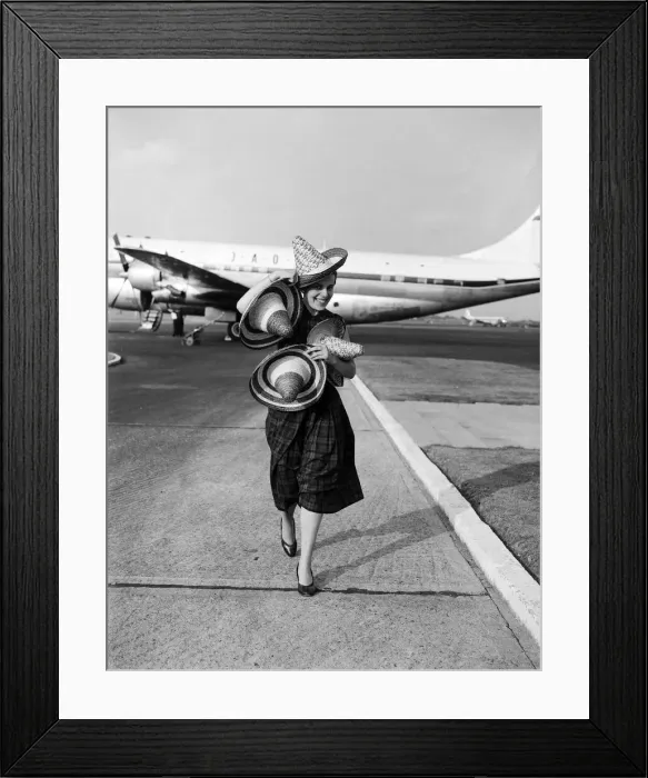 Framed Print : School teacher, 23 year old Phyllis Kaulfman, is not short of hats for her flight home Framed Print : School teacher, 23 year old Phyllis Kaulfman, is not short of hats for her flight home