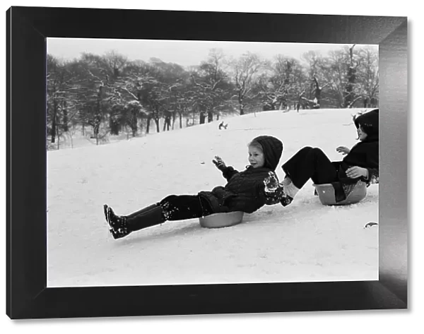 Children sledging on washing up bowls in Greenwich Park, London, 27th December 1970