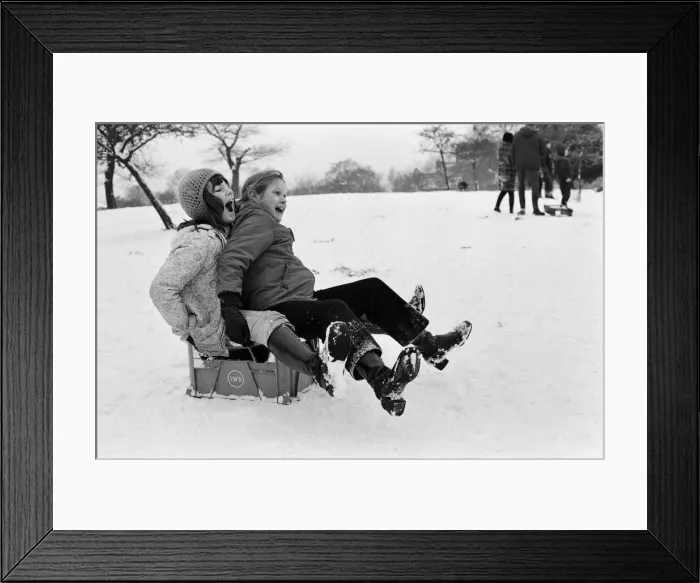 Framed Print : Children sledging on a milk crate in Greenwich Park, London, 27th December 1970 Framed Print : Children sledging on a milk crate in Greenwich Park, London, 27th December 1970