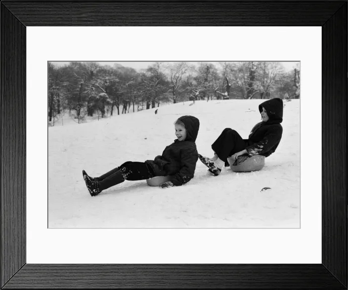 Framed Print : Children sledging on washing up bowls in Greenwich Park, London, 27th December 1970 Framed Print : Children sledging on washing up bowls in Greenwich Park, London, 27th December 1970