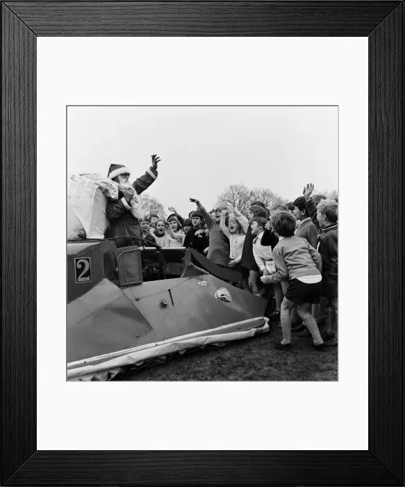 Framed Print : Father Christmas arrives by hovercraft at Freegrounds Park Infant & Junior School