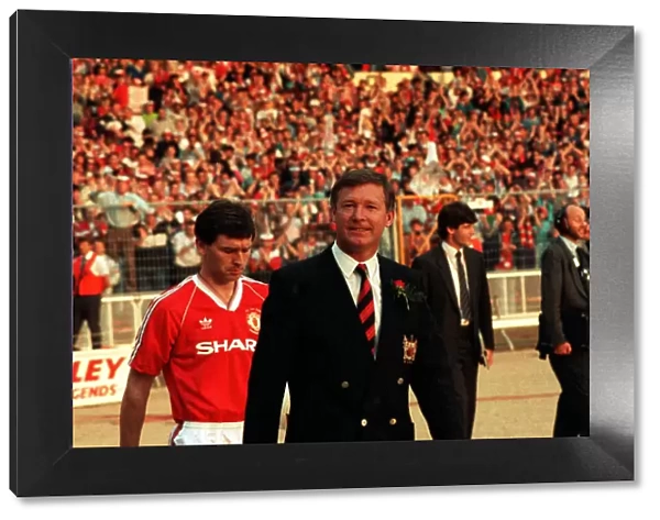 Sir Alex Ferguson leads the team out, followed by Bryan Robson
