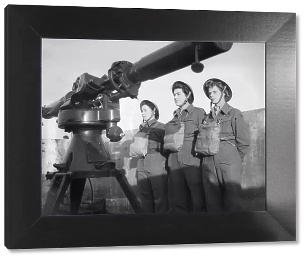 Women of the ATS operating the height finder optics at an anti aircraft battery in