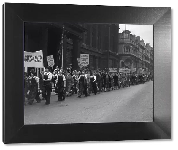 Women munition workers parade through central Birmingham as part of War Production Worker