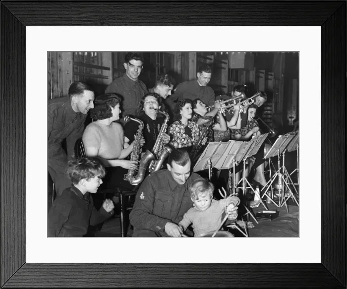 Framed Print : An Army band plays with wives and girlfriends during some off duty leisure time in Framed Print : An Army band plays with wives and girlfriends during some off duty leisure time in
