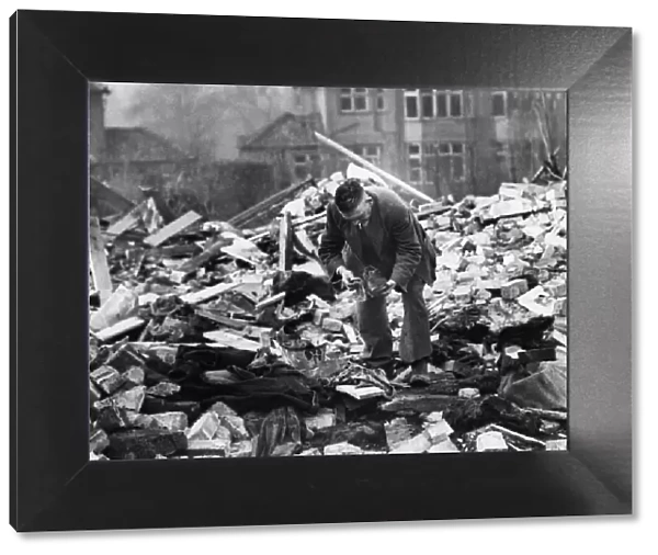 A man searches among the debris of his destroyed home in Wavertree