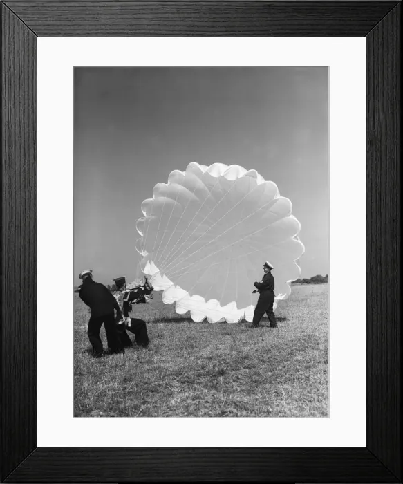 Framed Print : Fleet Air Arm parachute packers seen here testing a parachute at an un-named Royal Naval Framed Print : Fleet Air Arm parachute packers seen here testing a parachute at an un-named Royal Naval