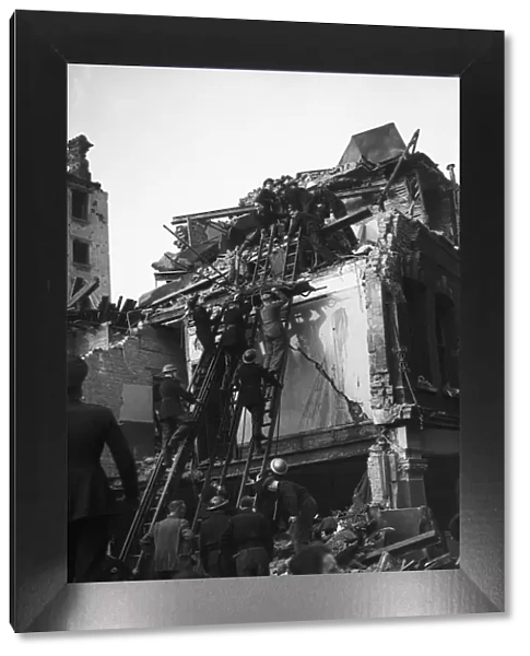 Rescue workers search through the rubble and wreckage of Warwick Court, Holborn