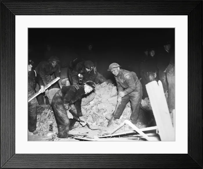 Framed Print : Rescue workers dig through the rubble after a V2 missile exploded at the junction of Framed Print : Rescue workers dig through the rubble after a V2 missile exploded at the junction of