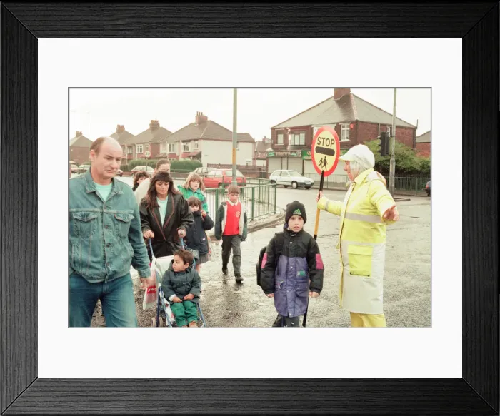 Framed Print : Lollipop lady Janet Taylor on duty at the junction of Trunk Road with Kings Road Framed Print : Lollipop lady Janet Taylor on duty at the junction of Trunk Road with Kings Road