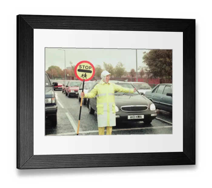 Framed Print : Lollipop lady Janet Taylor on duty at the junction of Trunk Road with Kings Road Framed Print : Lollipop lady Janet Taylor on duty at the junction of Trunk Road with Kings Road