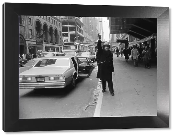 A doorman hailing a cab in New York, 13th February 1981