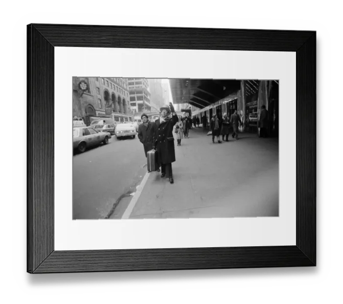 Framed Print : A doorman hailing a cab outside a Hotel. New York, 13th February 1981