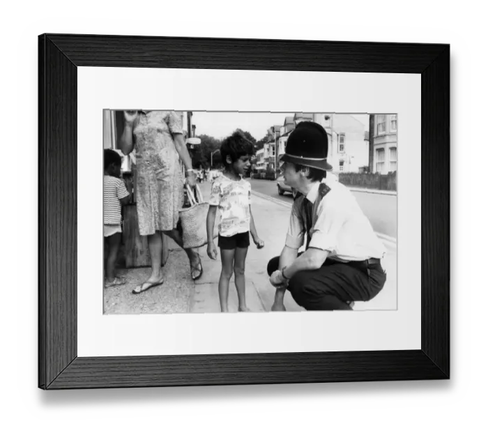 Framed Print : PC Nigel Barber speaks with a young boy, during patrol pod the streets of Cambridge