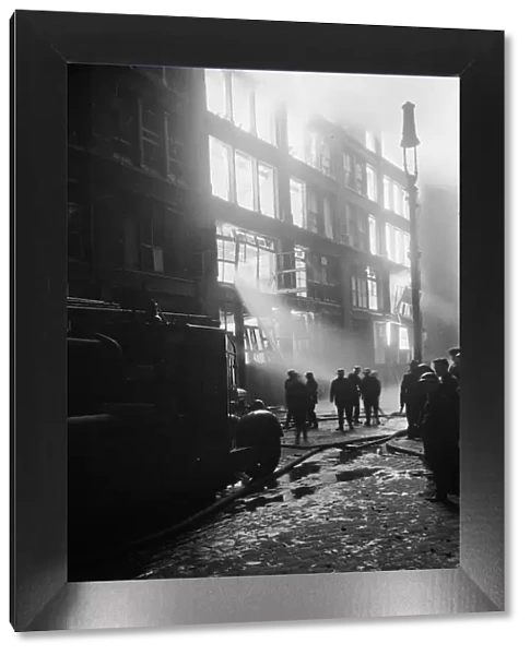 Firemen attempt to control a fire in Shoreditch, London
