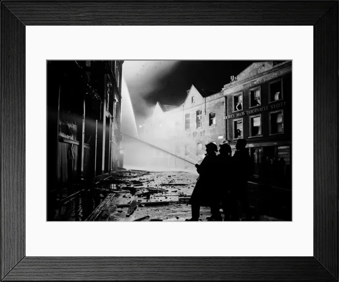 Framed Print : Members of the Auxiliary Fire Service and London Fire Brigade seen here fighting a fire