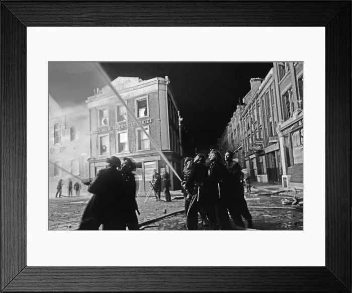Framed Print : Members of the Auxiliary Fire Service and London Fire Brigade seen here fighting a fire
