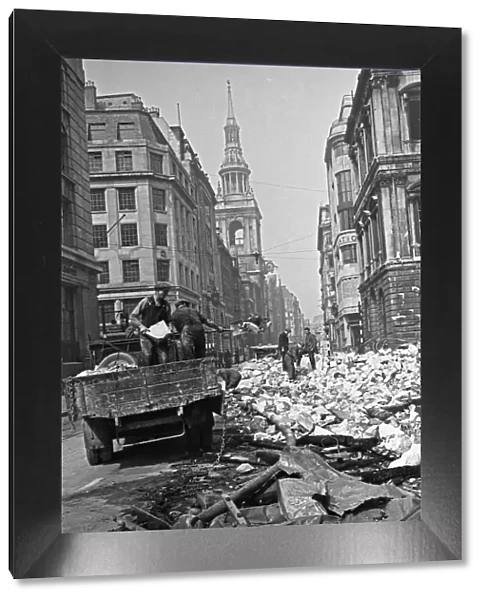 Workmen clear rubble from the Cheapside, City of London, the spire of St Mary-le-Bow