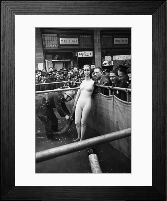Framed Print : Auxiliary fireman seen here inspecting a water supply tank outside an Abbotts Shoe Shop Framed Print : Auxiliary fireman seen here inspecting a water supply tank outside an Abbotts Shoe Shop