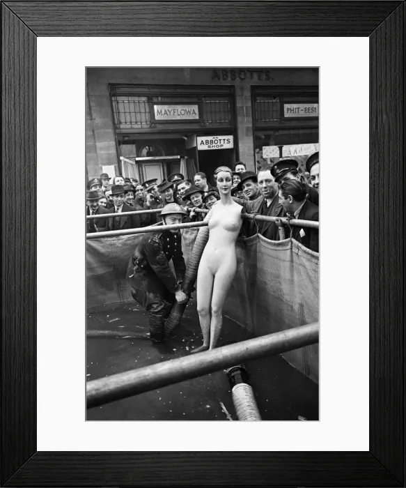 Framed Print : Auxiliary fireman seen here inspecting a water supply tank outside an Abbotts Shoe Shop Framed Print : Auxiliary fireman seen here inspecting a water supply tank outside an Abbotts Shoe Shop