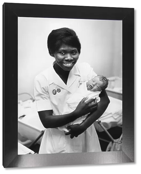 Nurse with a newborn baby at a hospital in Cambridge. Circa 1964