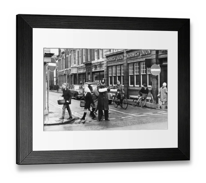 Framed Print : Picture shows a policeman on St Andrews Street, Cambridge, allowing traffic past