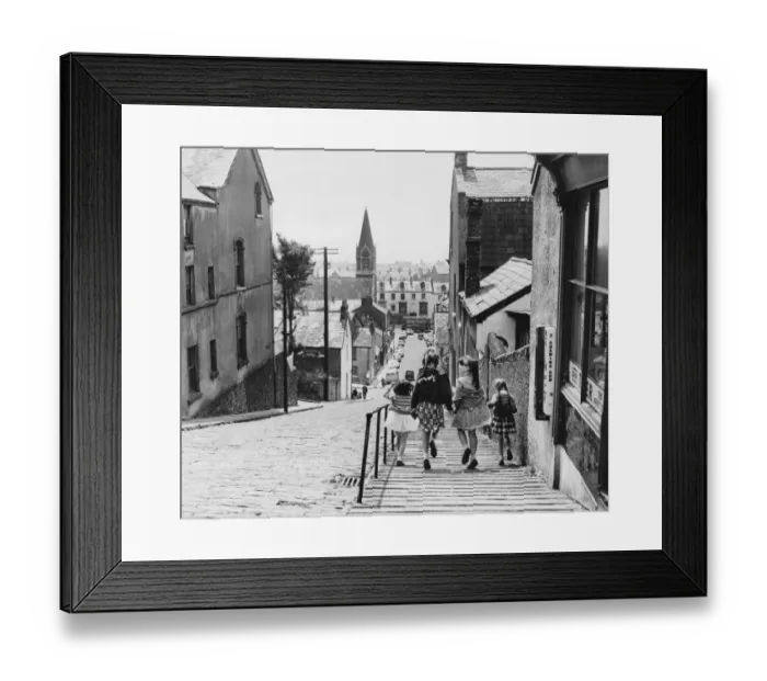 Framed Print : Swansea. Where cobbles are yet to giveaway to modern flagstones these four happy Framed Print : Swansea. Where cobbles are yet to giveaway to modern flagstones these four happy