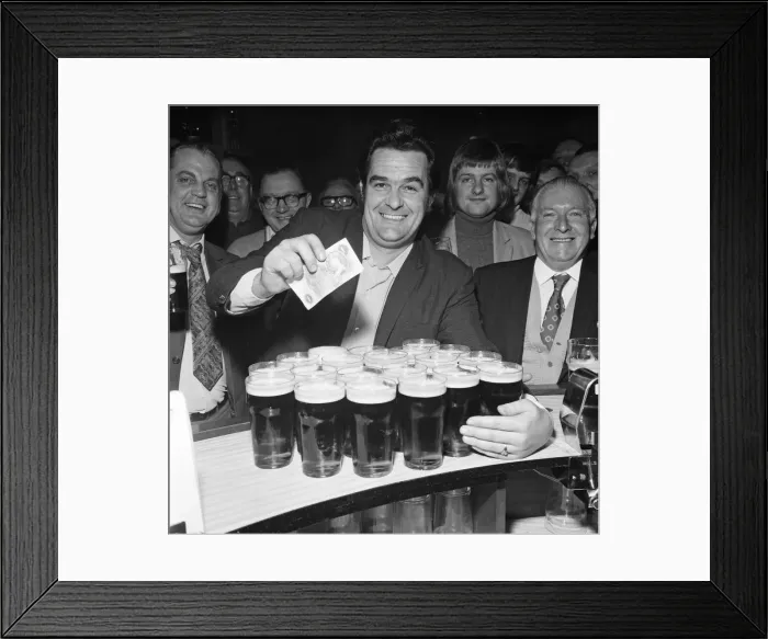 Framed Print : A drinkers dream - man with twenty pints in the pub. 1st January 1973