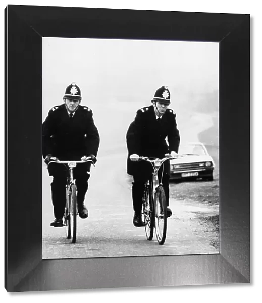 Two rural Police constables doing their rounds on bicycle at Newmarket, Cambridgeshire