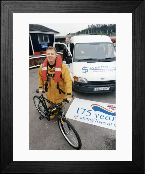 Framed Print : RNLI crew member with bicycle. Circa 1990s Framed Print : RNLI crew member with bicycle. Circa 1990s