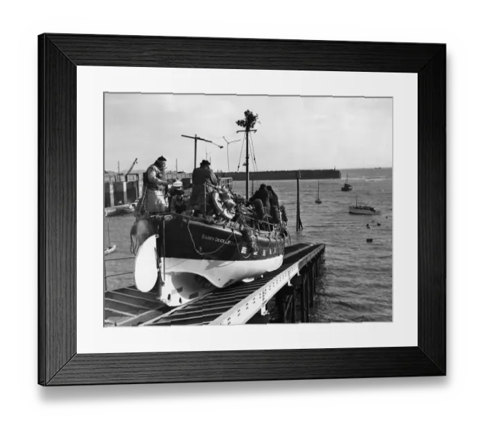 Framed Print : The Barry Dock lifeboat slides down the slipway as she leaves dock to deliver Christmas Framed Print : The Barry Dock lifeboat slides down the slipway as she leaves dock to deliver Christmas