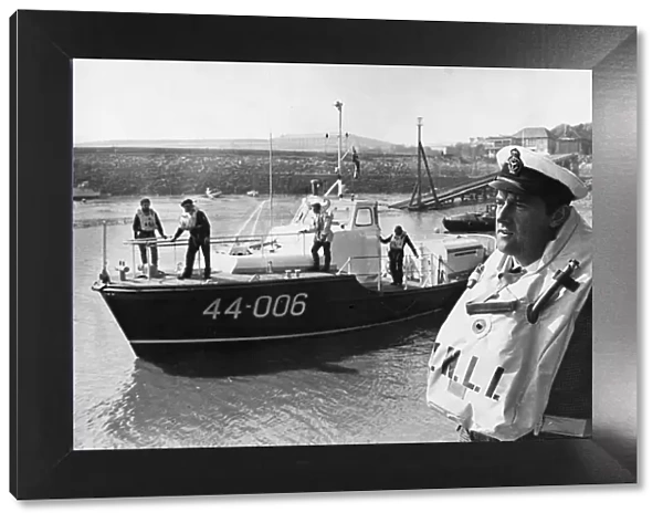 The Barry coxswain, Mr. Frank Tinsley, ready to board one of the Royal National Lifeboat