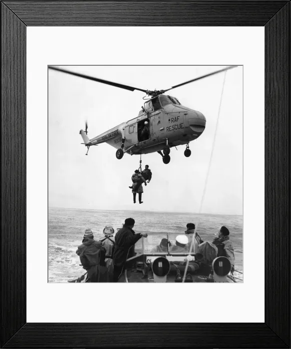 Framed Print : Two airmen are hoisted to the safety of an RAF helicopter after being picked up by Barry Framed Print : Two airmen are hoisted to the safety of an RAF helicopter after being picked up by Barry