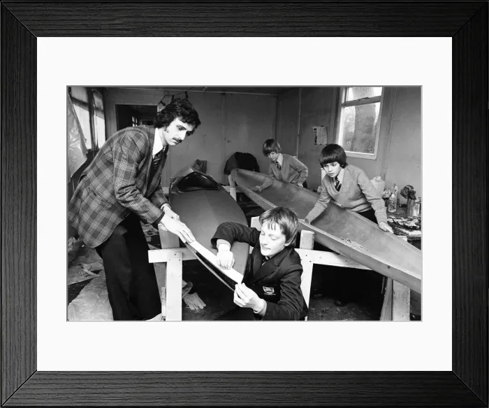 Framed Print : Children at Sarah Metcalfe School build a canoe in Wood shop class, Middlesbrough Framed Print : Children at Sarah Metcalfe School build a canoe in Wood shop class, Middlesbrough