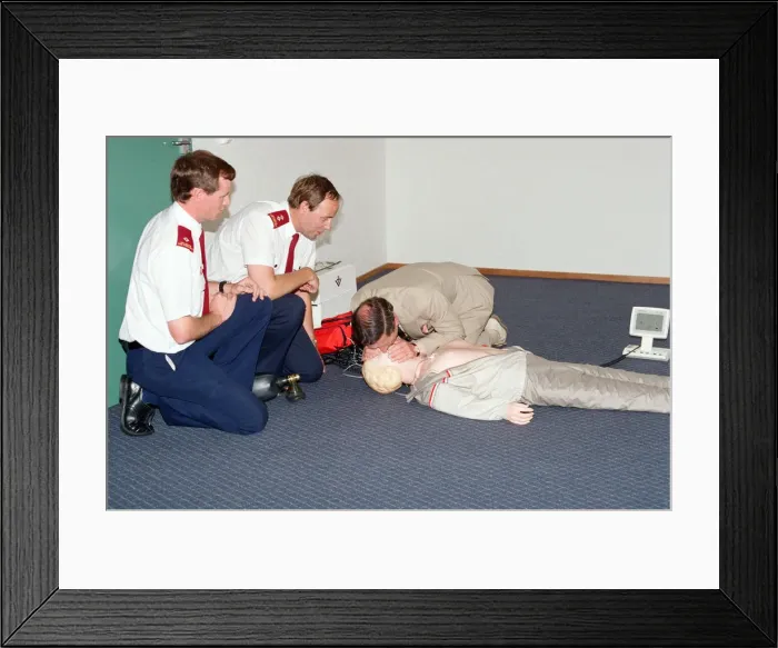 Framed Print : Prince Charles demonstrating resuscitation techniques on an inflatable doll at an