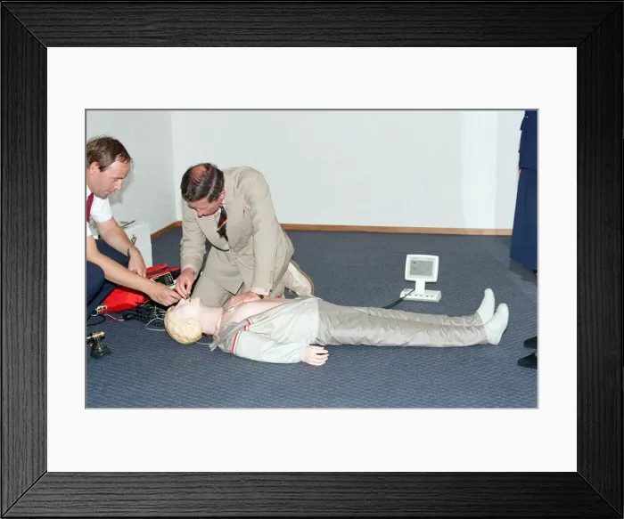 Framed Print : Prince Charles demonstrating resuscitation techniques on an inflatable doll at an Framed Print : Prince Charles demonstrating resuscitation techniques on an inflatable doll at an