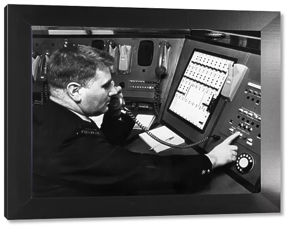 Fireman demonstrates new electronic private circuit system installed in Control Room at