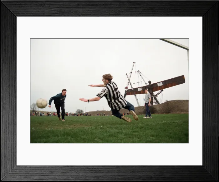 Framed Print : A football game takes place in front of the Angel of the North, Gateshead Framed Print : A football game takes place in front of the Angel of the North, Gateshead