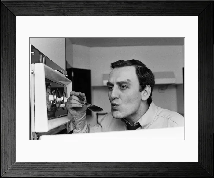 Framed Print : Actor John Thaw has been his own chef for many years. He checks the sauce from one his Framed Print : Actor John Thaw has been his own chef for many years. He checks the sauce from one his