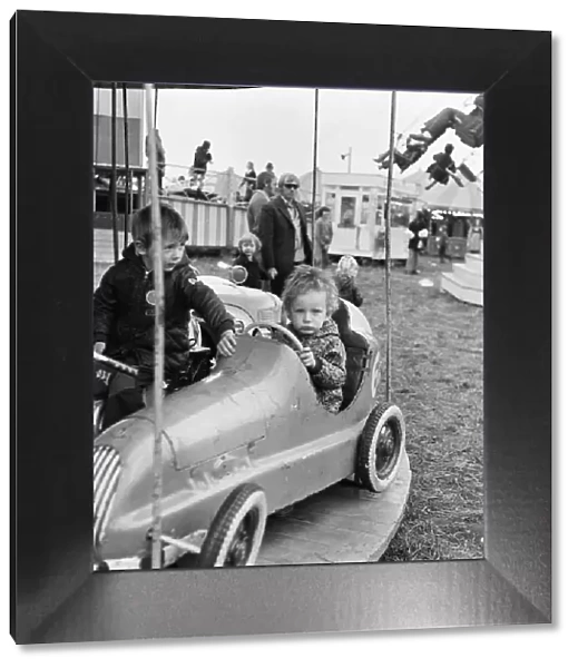 A small child enjoying the thrill of the merry-go-round at Silcocks Fair at Skelmersdale