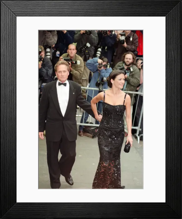 Framed Print : Catherine Zeta-Jones and Michael Douglas at the film premiere of Entrapment