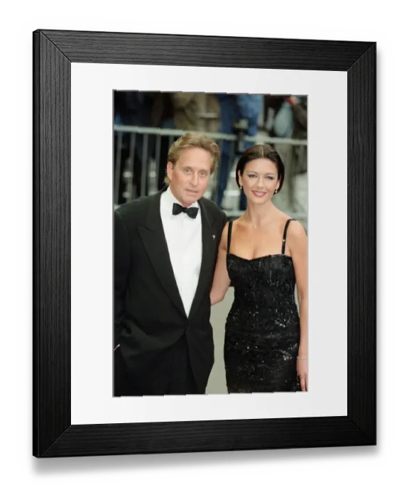 Framed Print : Catherine Zeta-Jones and Michael Douglas at the film premiere of Entrapment